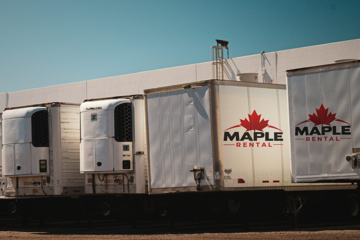 Row of Maple Rental reefer and dry van trailers lined up in the yard